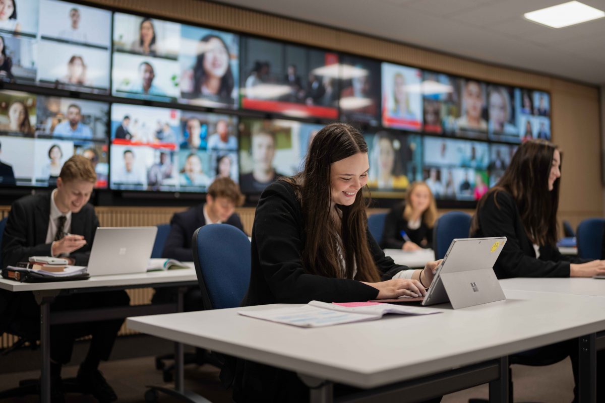 X2O OneRoom hybrid learning session with remote and in-room participants engaging in an interactive classroom experience.